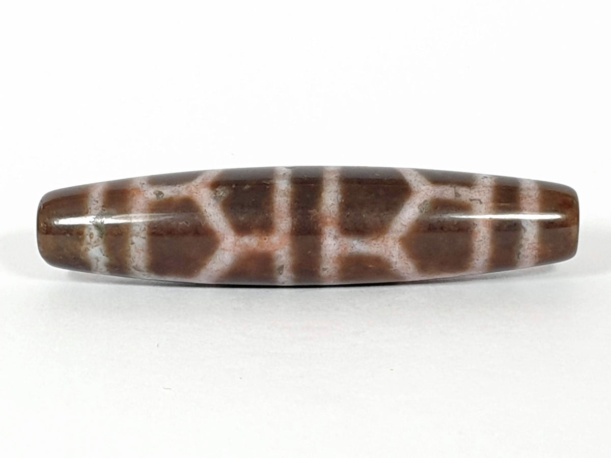 N-062226-DLBS, face B, double longevity cell grid, warm medium-dark brown ground, dusty rose-cream lines, unretouched