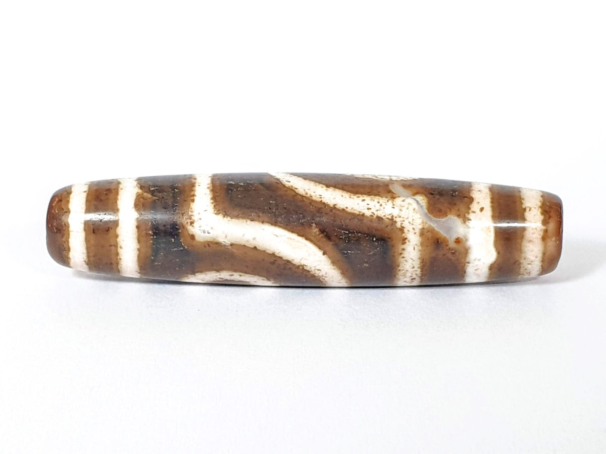 Qing Dynasty two eye dzi — reverse face, angular wave connector lines on dark brown-black ground, cream zones, At-0426-2EQ