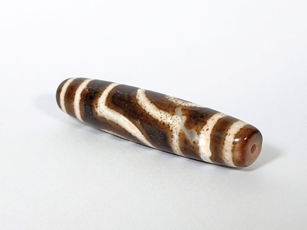 Qing Dynasty two eye dzi — opposite angled end, drill hole at warm brown left tip, dark brown cream stripe body, At-0426-2EQ