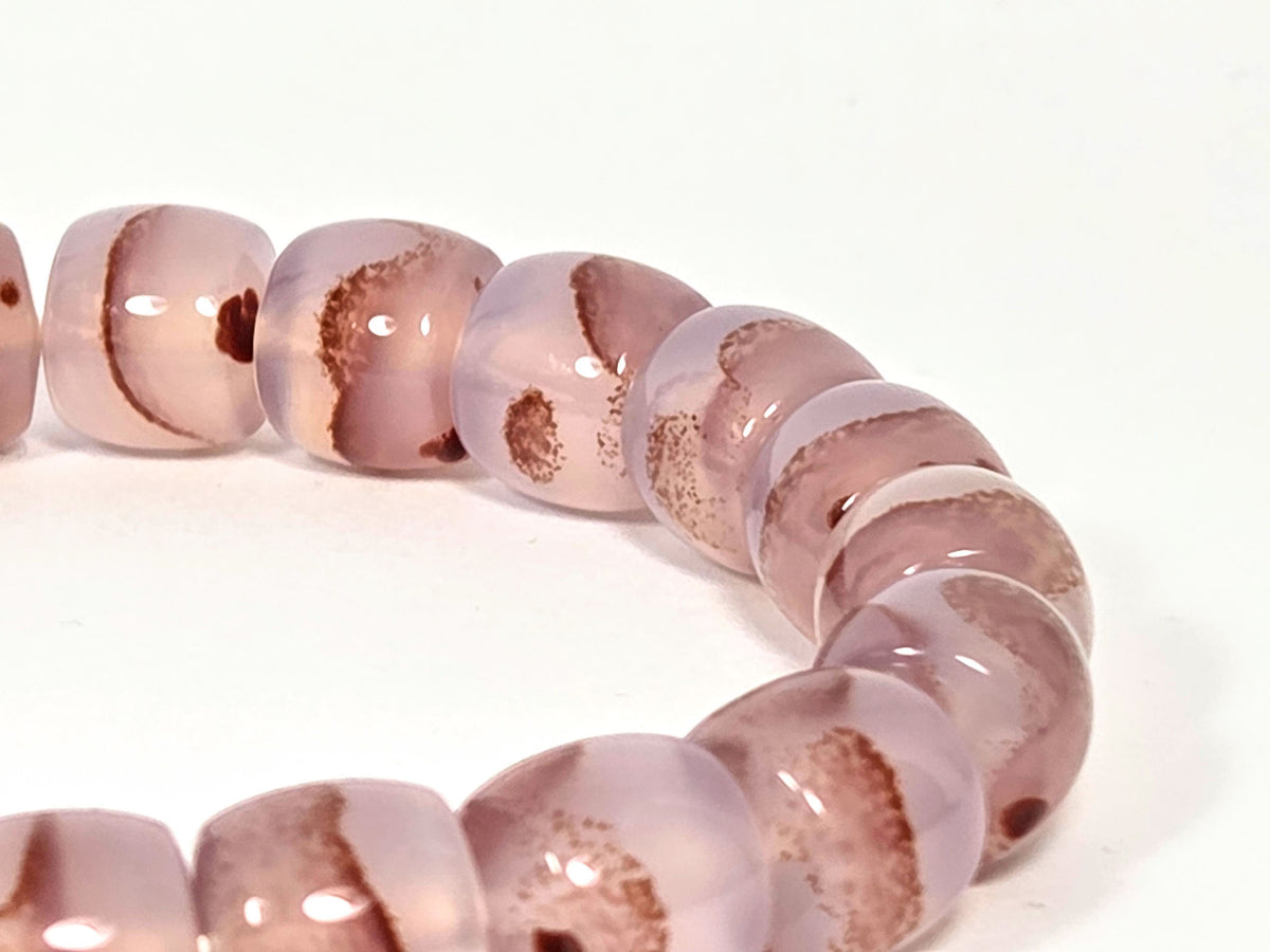 N-030526-CB2 macro, dense dark brown-red cinnabar cluster groupings in mauve-rose chalcedony, unretouched