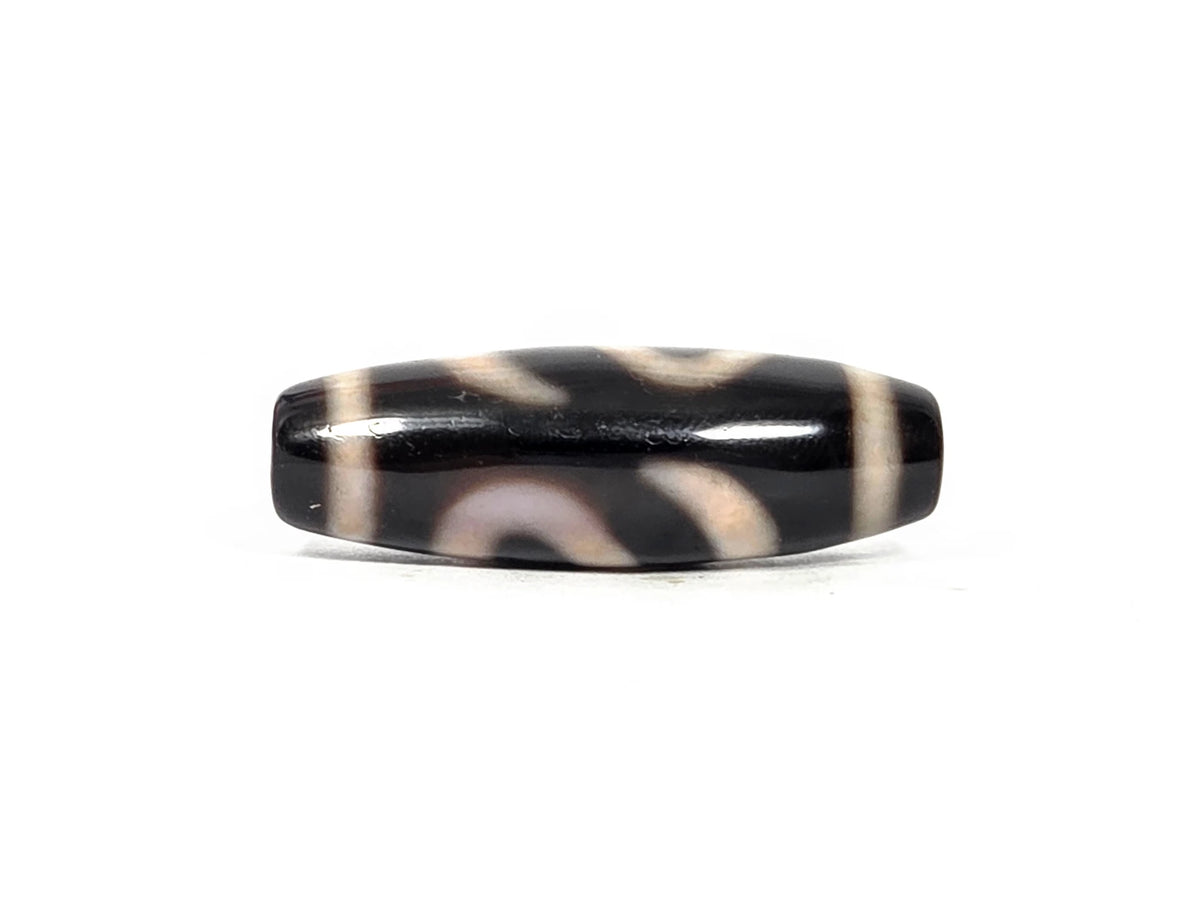Fourth lateral profile of antique Tibetan money hook dzi bead showing full motif composition with horizontal cream band lines at both end cap zones on pitch-black agate ground, 100–300 years old