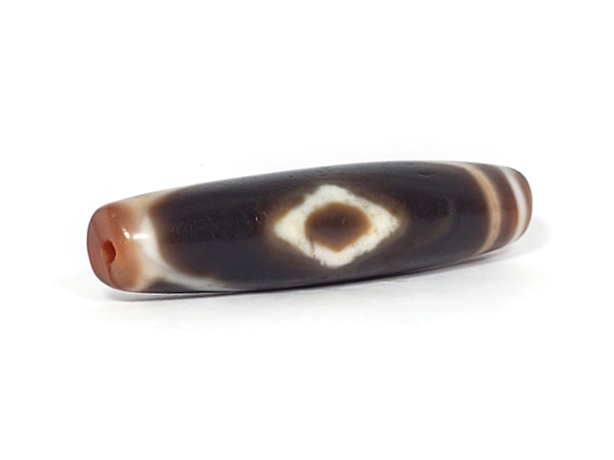 At-061926-3DE2 angled tip A, elongated fusiform form, warm reddish-brown end cap, unretouched