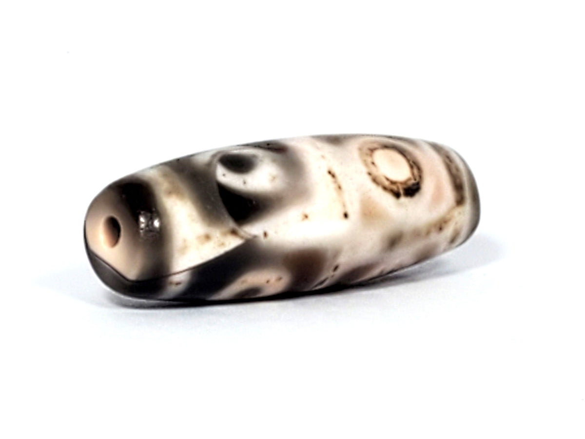 Six Eye Dzi bead, pale warm-brown agate with cinnabar bloodspots, 35mm, polished surface with visible drill holes