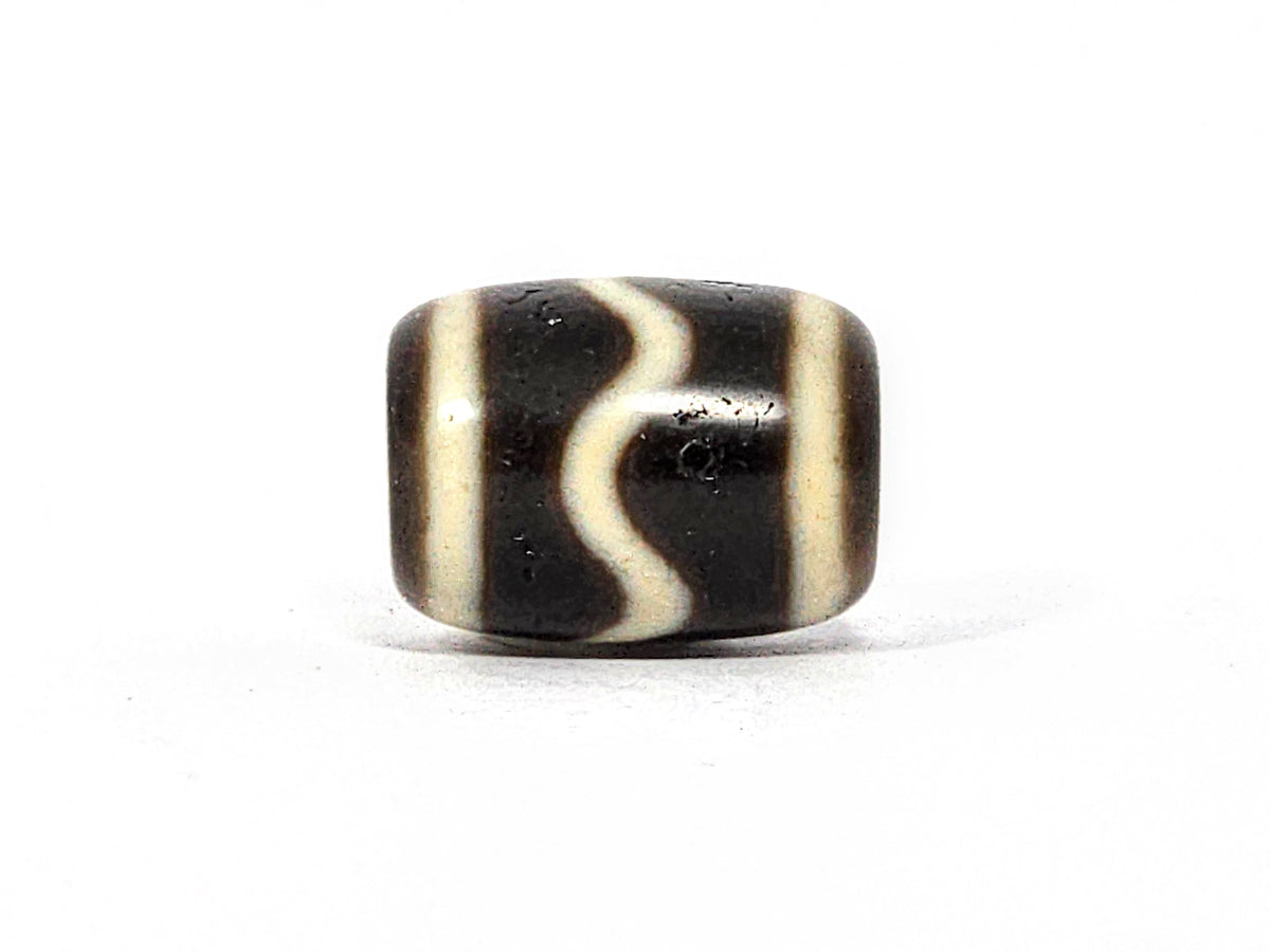 Antique wave motif dzi bead, black and white agate, S-curve stripe pattern, barrel shape, aged patina, visible surface wear