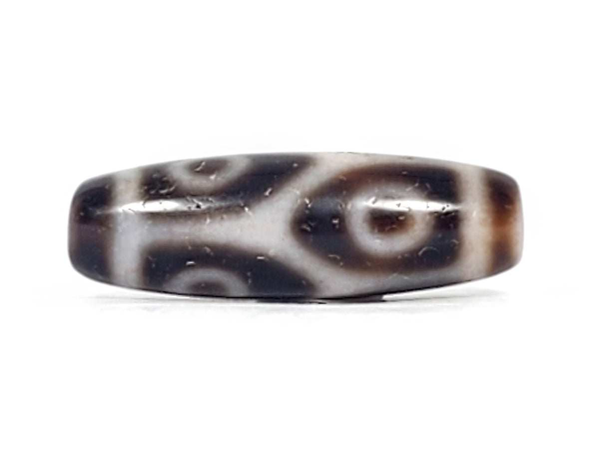 Antique Tibetan six-eye lotus dzi bead, dark agate, white eye motifs, bloodspots, aged patina, drilled ends