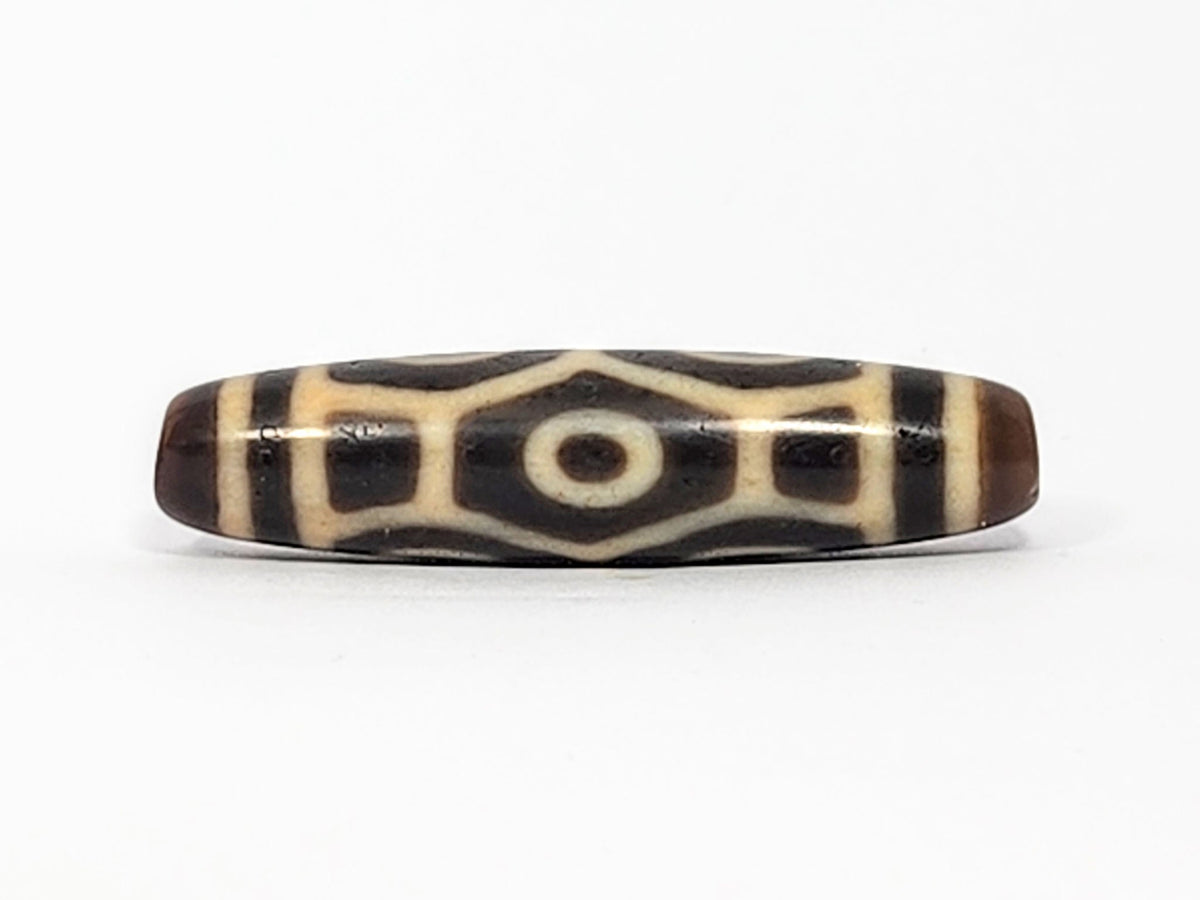 Antique Tibetan Naga dzi bead face D showing hexagonal body scale with squared rectangular dark panels, At-050725-6EN3