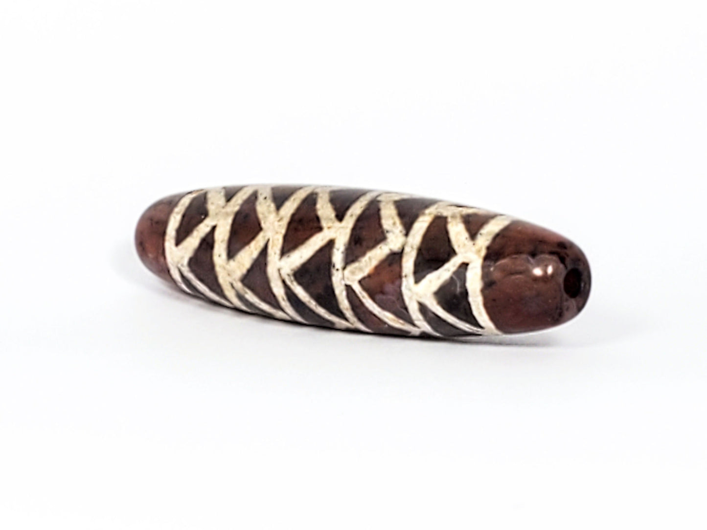 At-040524-TTStr antique carnelian dzi, right end cap, warm reddish-brown cap, drill hole, motif wrap detail, unretouched