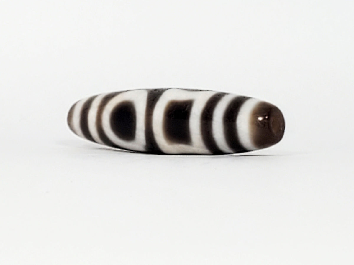 Antique heaven earth gate dzi — opposite end angled, drill hole at rich brown cap, two eye motifs on body, At-0426-DHE