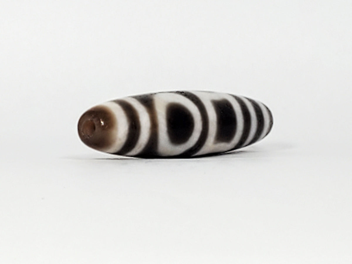 Antique heaven earth gate dzi — angled end, drill hole at tip, warm brown agate cap, eye and stripe motif, At-0426-DHE