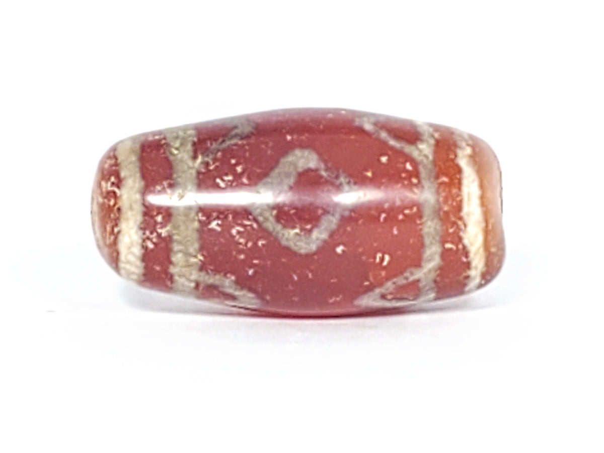 Face B of antique Three Diamond Eye Tiger Tooth dzi At-053126-3DETT, two diamond eye forms on warm terracotta-red agate ground, dark brown angular motif, 27.5mm, unretouched