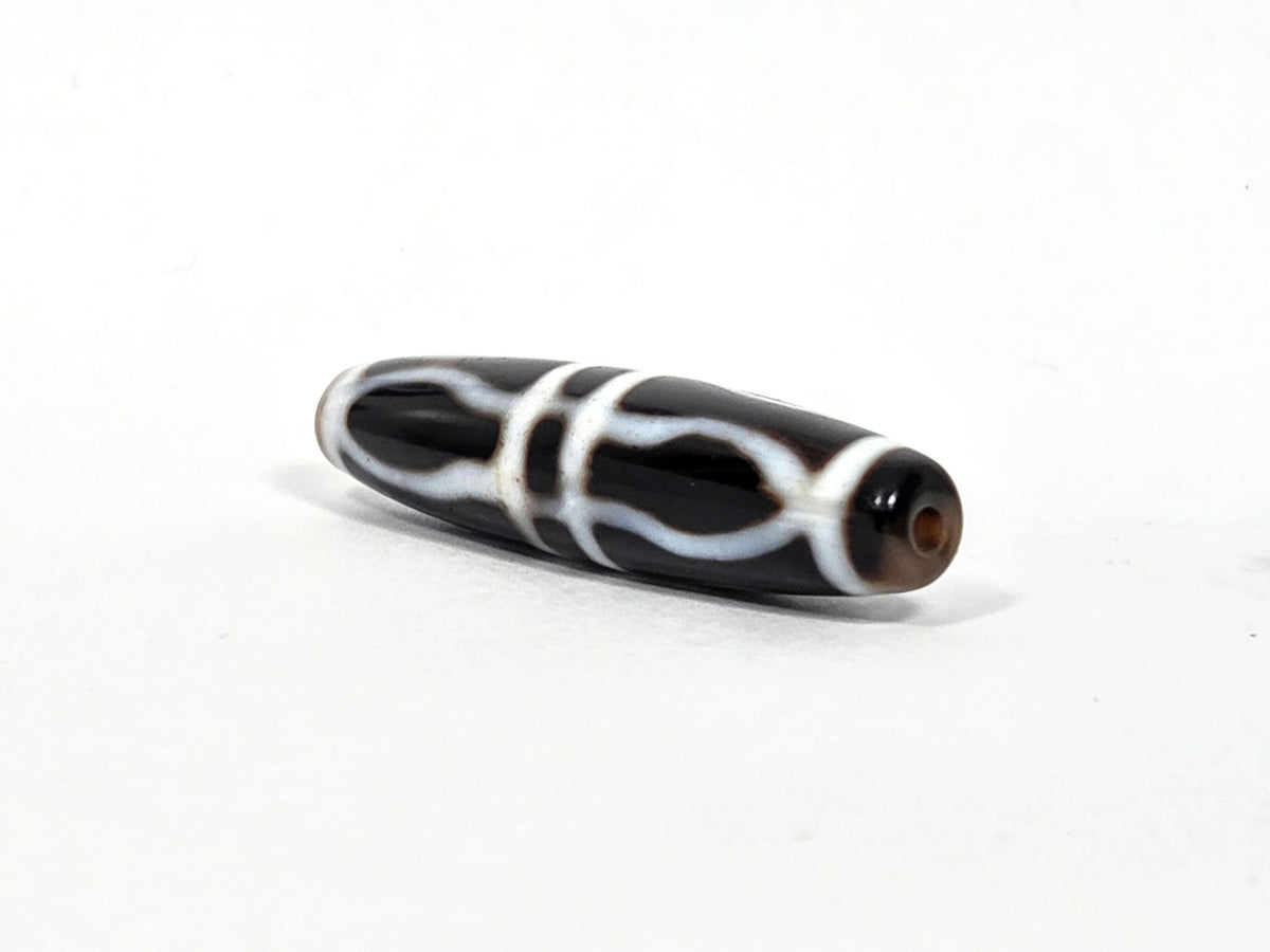 At-090226-3VJBS antique triple vajra dzi drill end view two warm medium brown tip agate unretouched