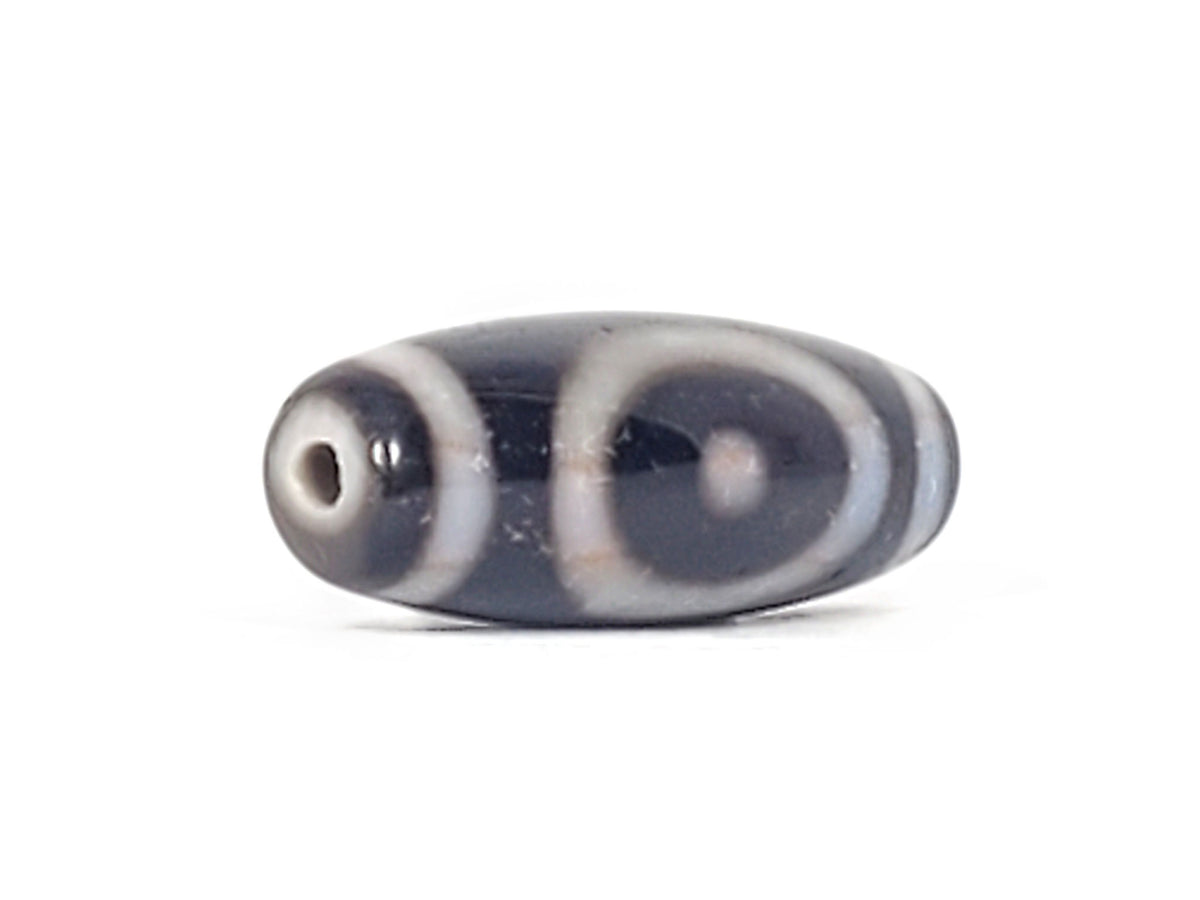 Antique heaven earth gate dzi — angled view, oval ring motif visible, drill hole at narrow right tip, At-0426-HGEG