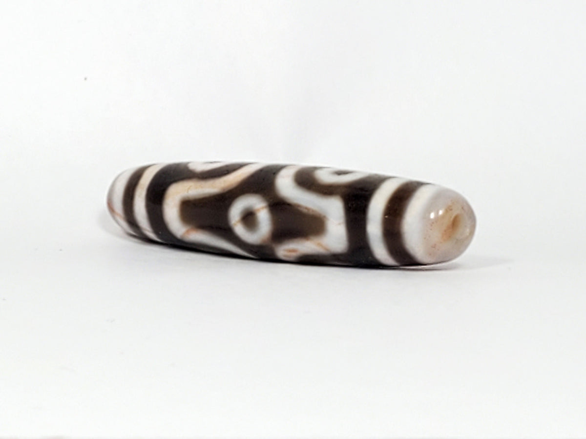 At-082824-6EBS2 end B sandy-cream cap slender spindle 57.7mm angular eye face visible dzi unretouched