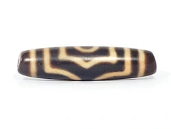 Antique three-eye dzi bead, dark brown agate with cream eye motifs, aged patina, oval barrel shape, visible drill holes