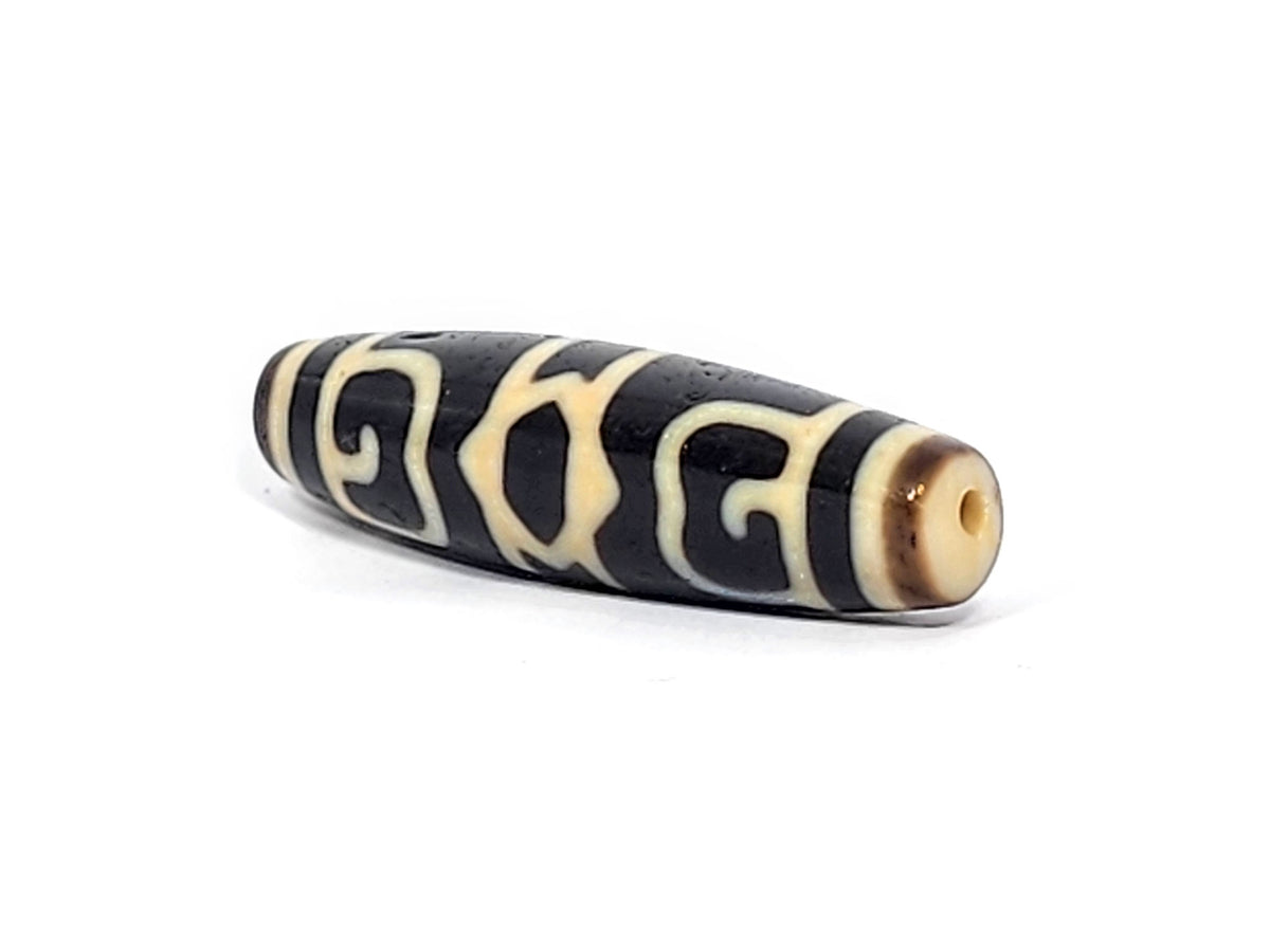 Guru Rinpoche's Dharma Cap Dzi bead, pitch-black agate with cream striped pattern, drilled through ends, 49.8mm length