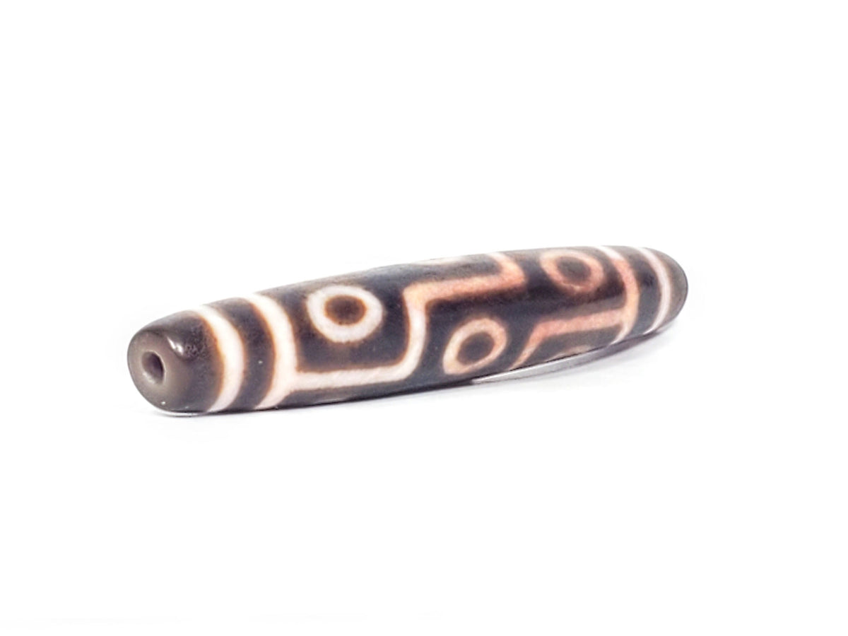 Nine-eye dzi bead, dark brown agate with cream patterns and bloodspots, drilled hole visible