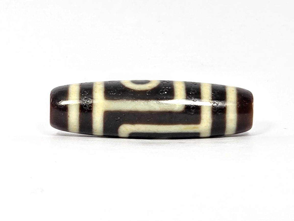 Two-eye dzi bead, dark brown and cream agate with striped pattern, polished surface, 39.9×11.6mm