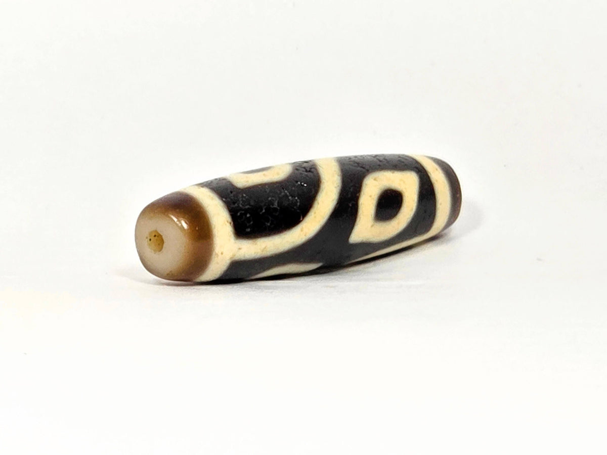Four eye dzi bead, dark brown and cream agate with drilled hole, natural patina