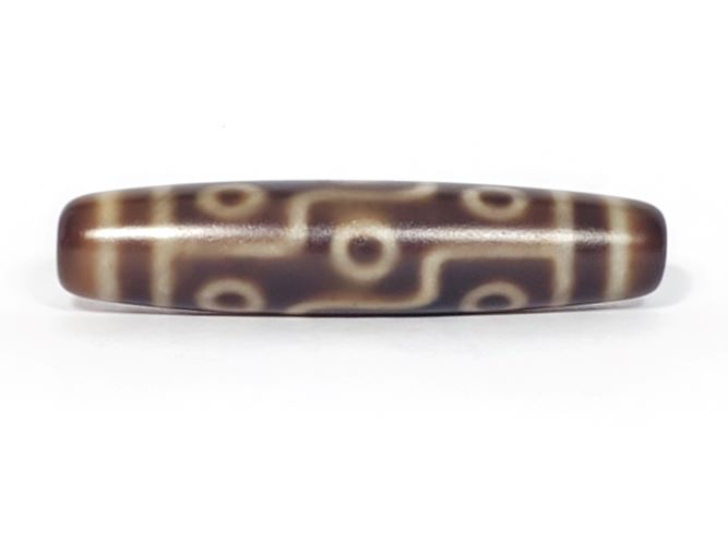 Nine-eye dzi bead with brown agate patterns, cream circular motifs, and natural striped patina finish