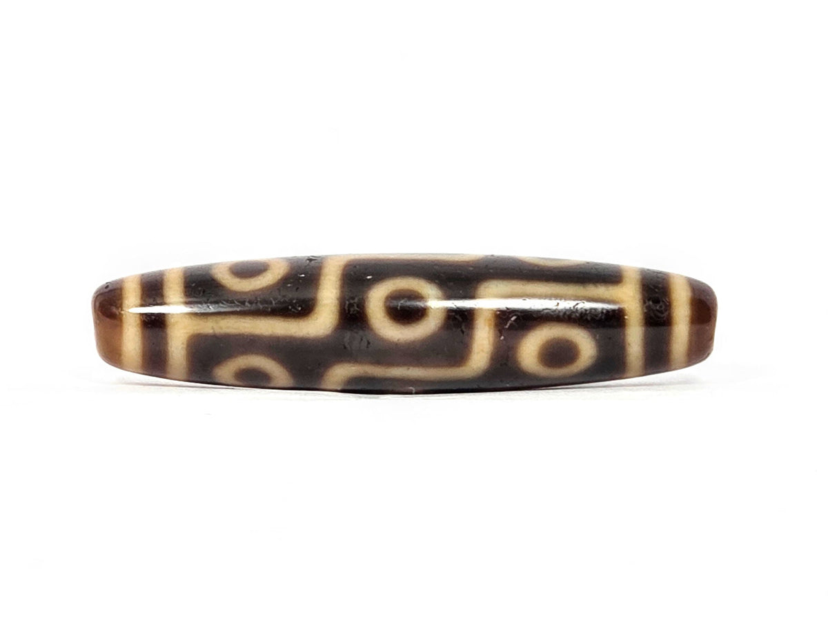 Antique Tibetan Nine Eye Dzi bead with cream and brown agate stripes, polished surface, center drill holes