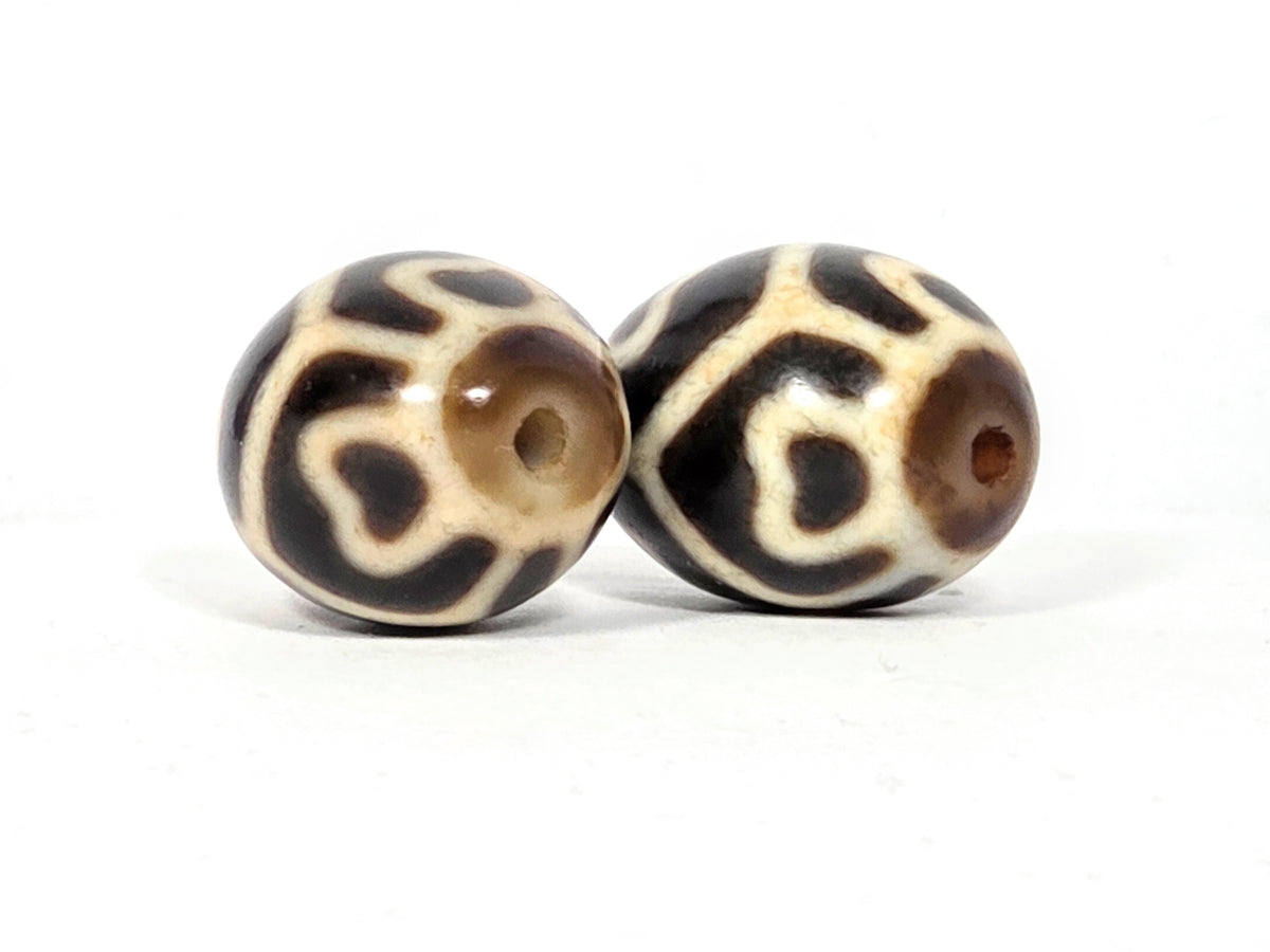 Pair of round six-eye Tibetan dzi beads with cream and brown agate pattern and central drill holes