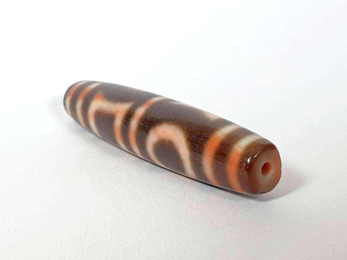 Antique Qing Dynasty double heaven earth dzi bead brown agate swirl motif visible drill hole natural patina
