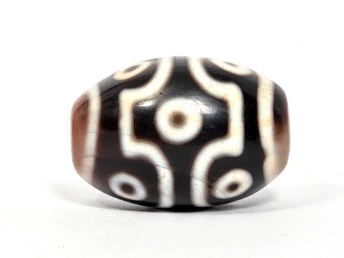 Rare ancient Tibetan nine-eye dzi bead with cream and black agate patterns, bloodspots, and natural patina