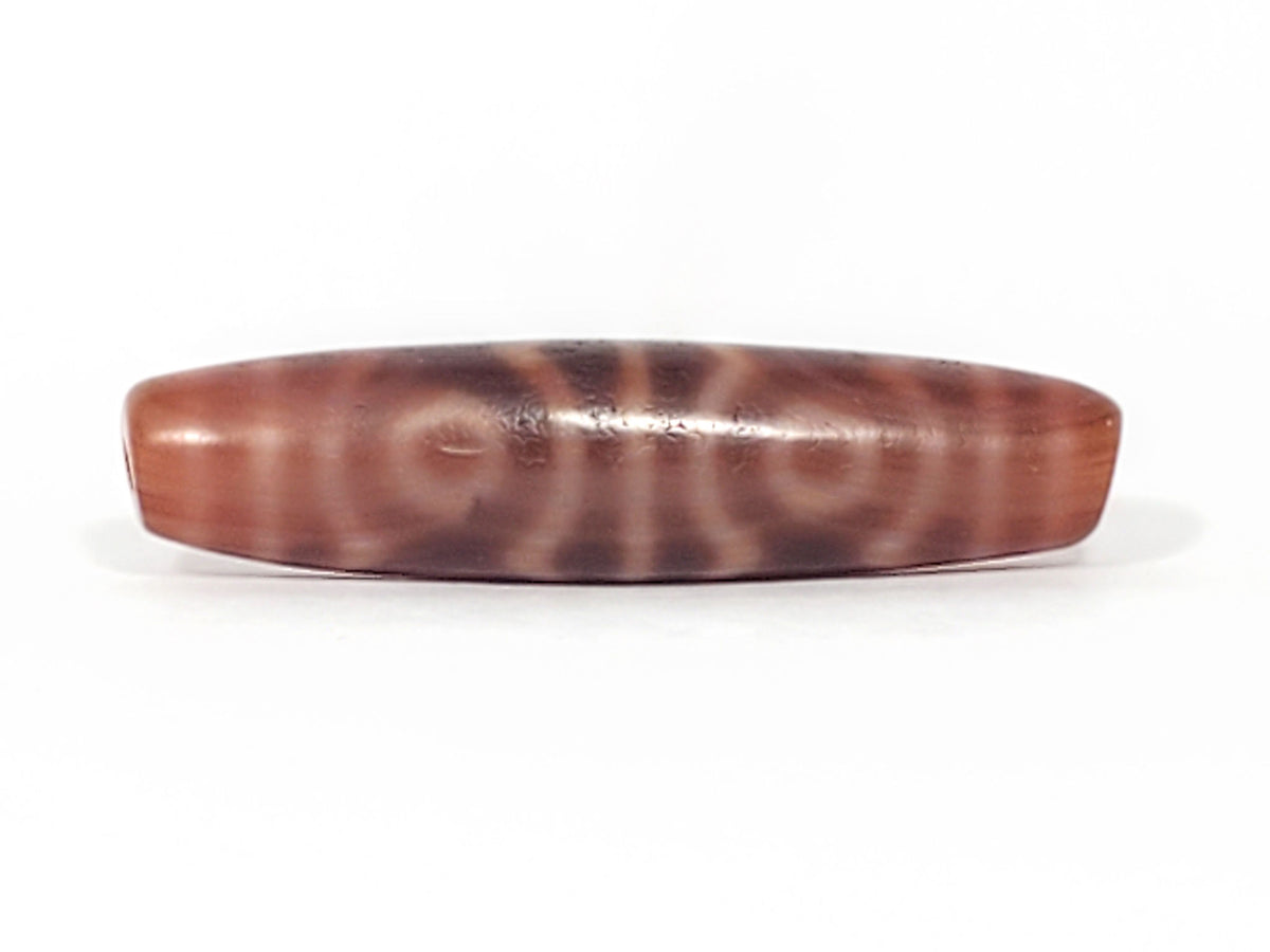 At-082624-6EBS, opposite end angled view, six concentric eyes wrapping full body, matte rose-brown agate, unretouched
