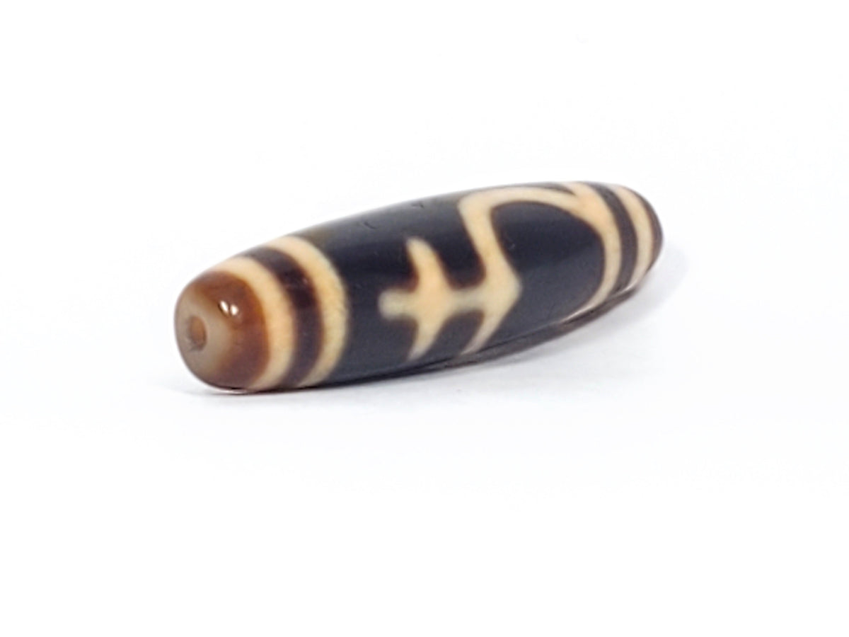 Antique Tibetan dzi bead treasure vase motif, dark agate, cream etched pattern, visible drill hole, aged patina