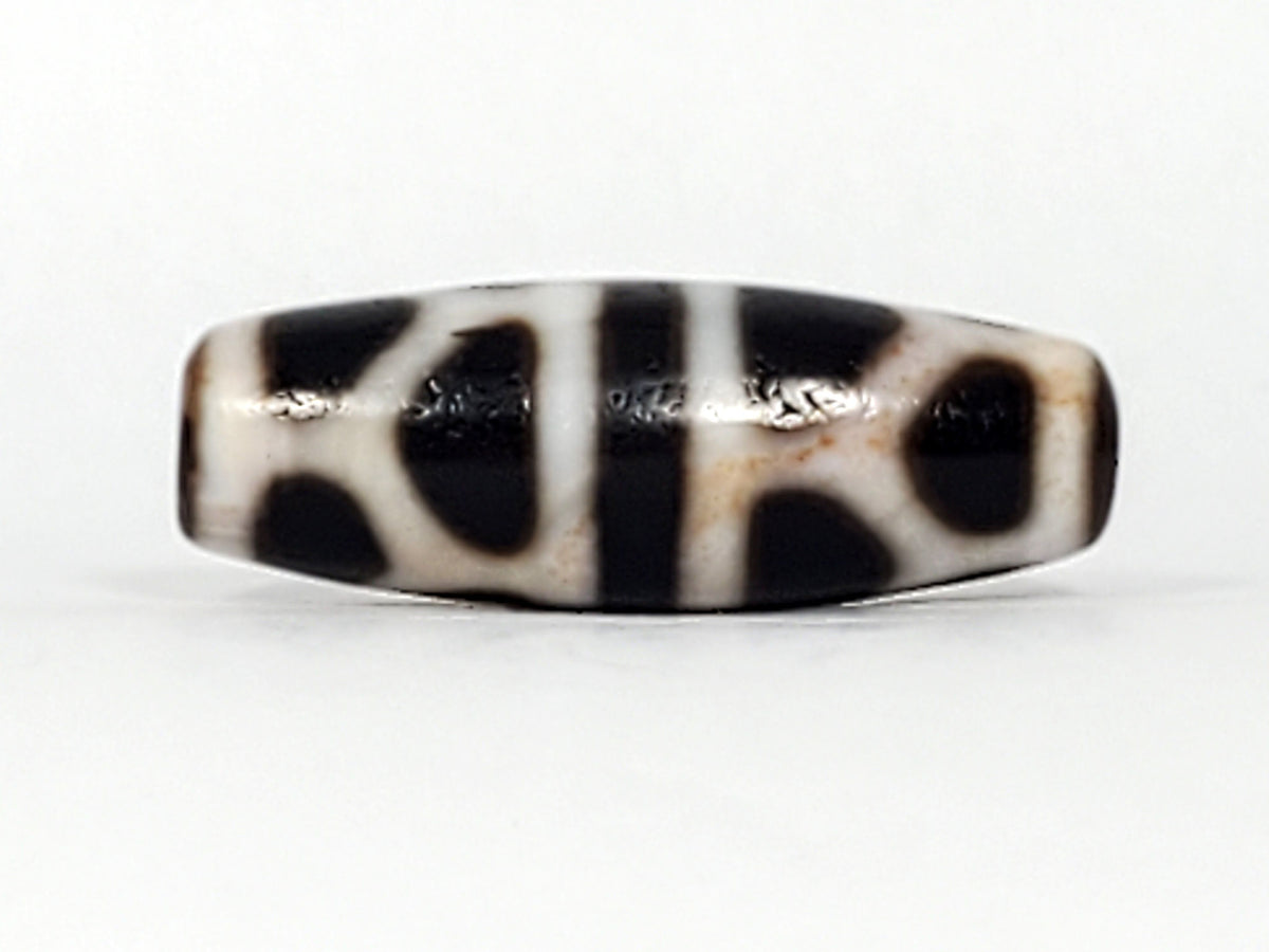 V-092824-DLBS Double Longevity dzi bead, alternate face, cream-white field with pitch-black enclosed shapes, unretouched