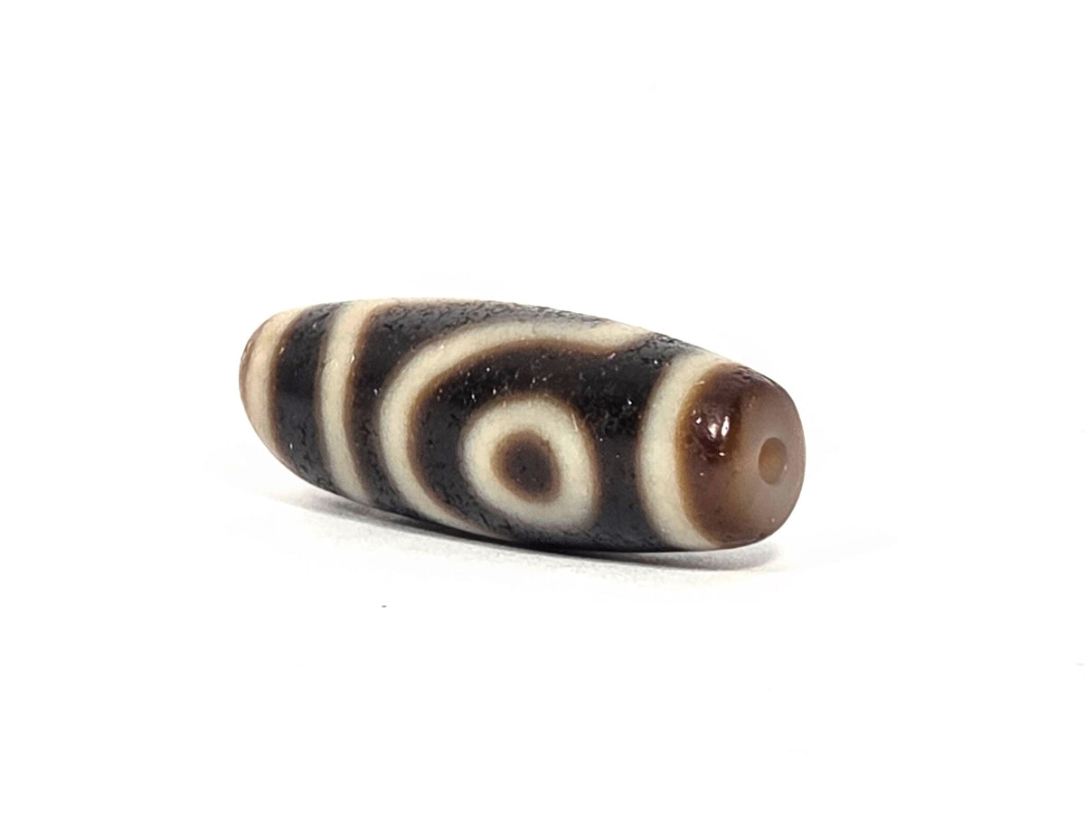 Two-eye dzi bead, black and cream striped agate, 34.3mm, drilled, ancient patina