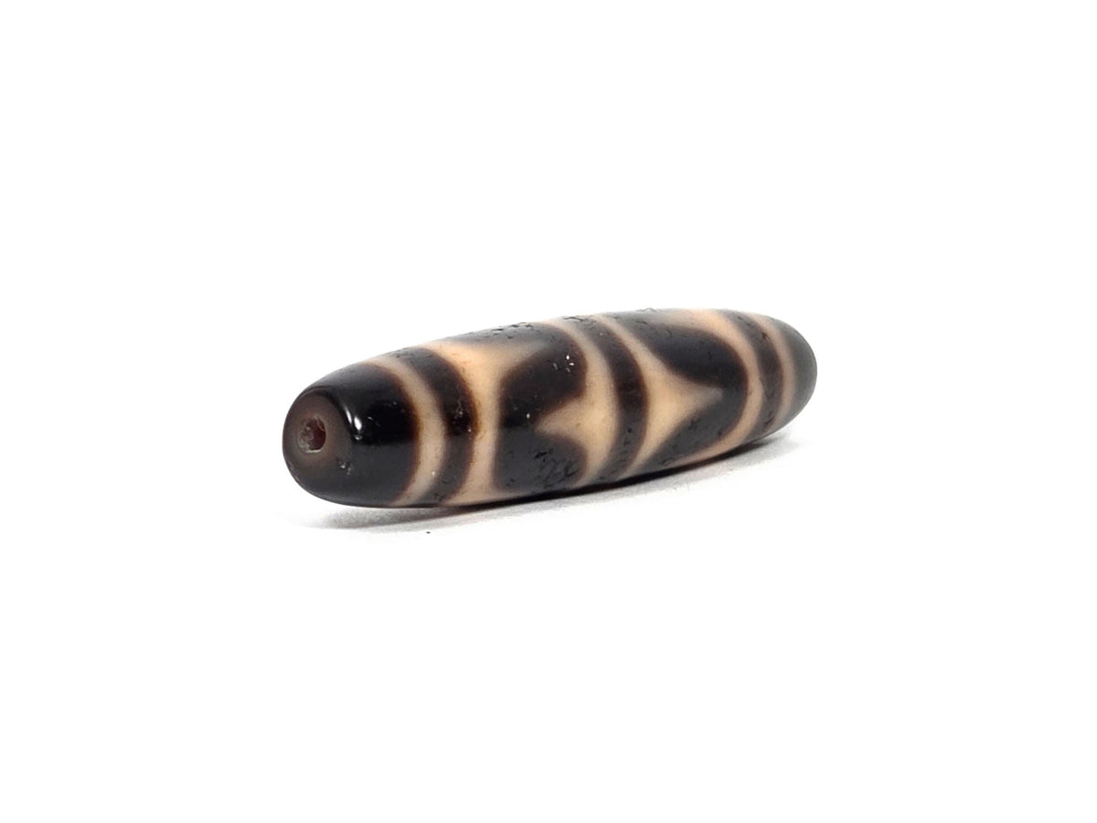 At-090226-DW6 antique double wave dzi dark agate, angled view opposite drill end wave band detail, unretouched
