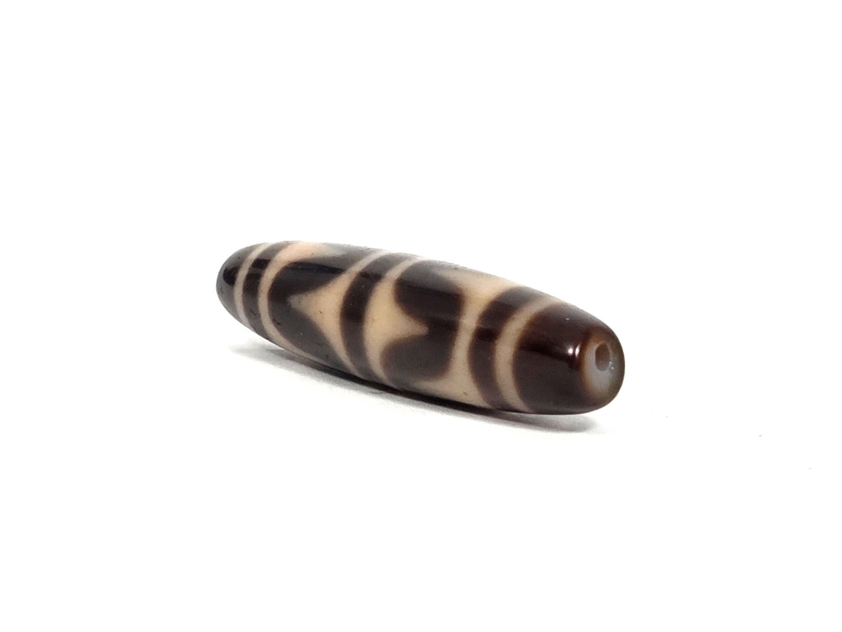 Dark brown agate dzi bead, double wave motif, cream stripe pattern, smooth polished surface, visible drill hole, 50mm elongated shape