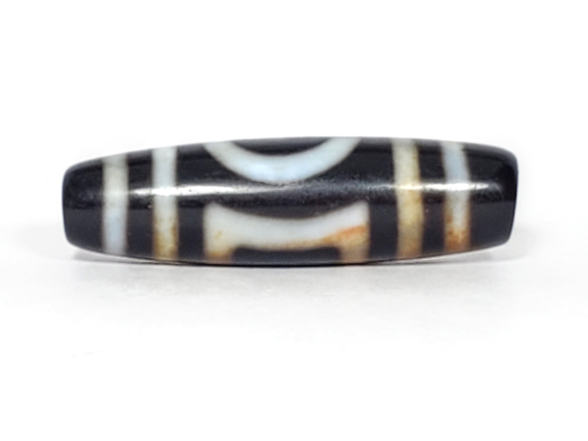 Antique dzi bead black agate Heaven's Gate Earth's Gate motif white stripes bloodspots patina elongated barrel shape