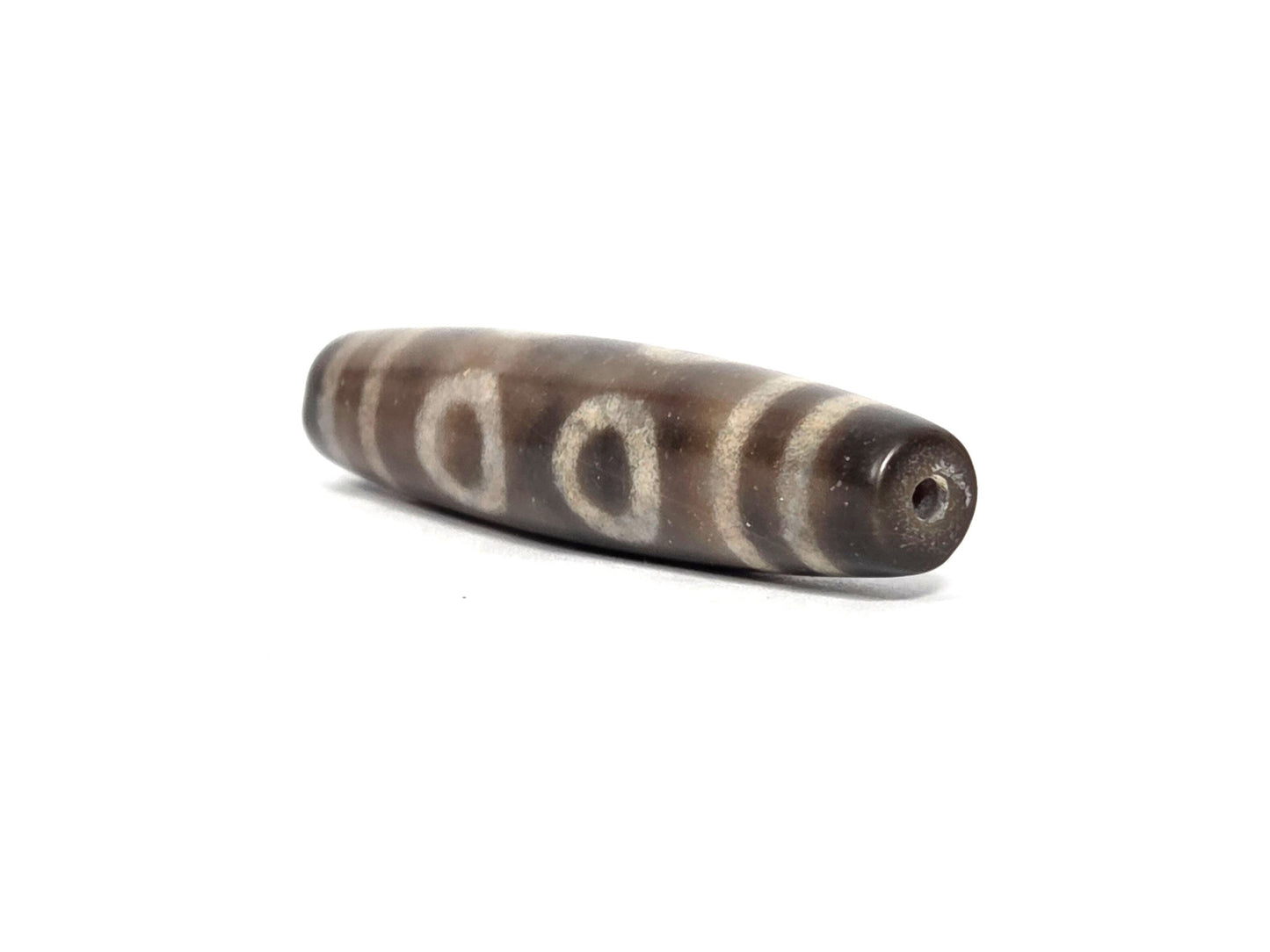 N-090326-6E new six eye dzi brown-grey agate angled drill end minor surface texture disclosed, unretouched