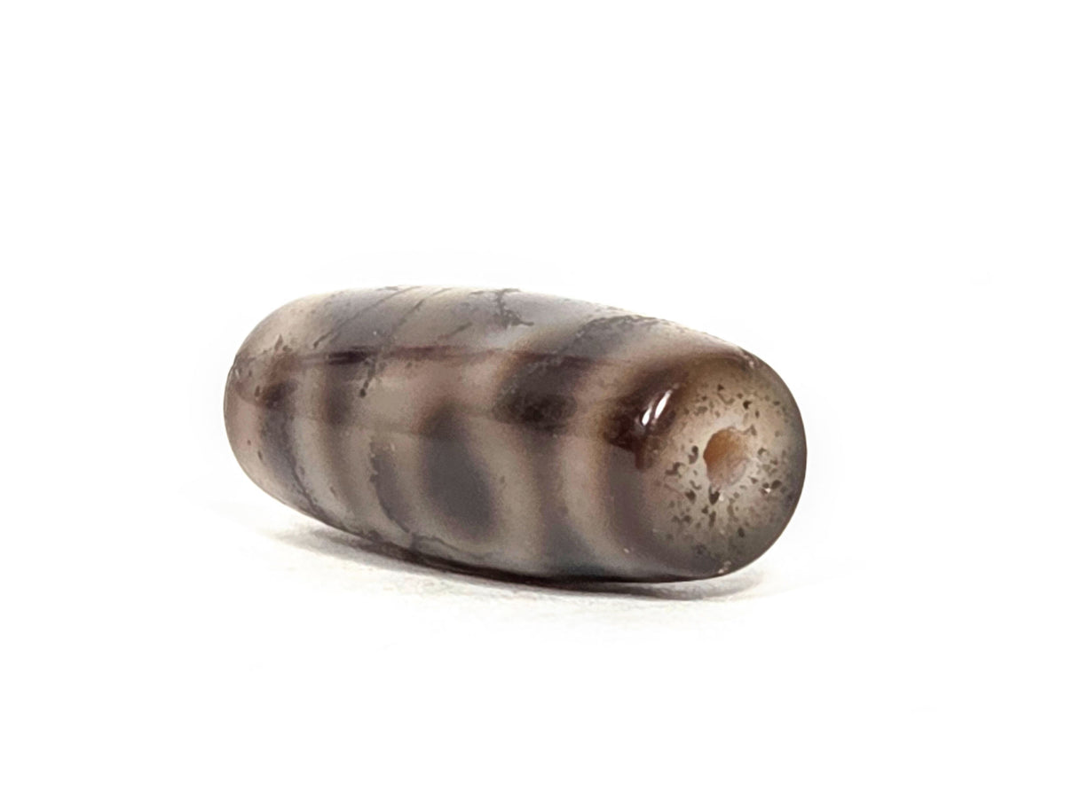 Four Activities Dzi bead, grey-brown agate with crackle finish, 27.3x11.5mm, drilled