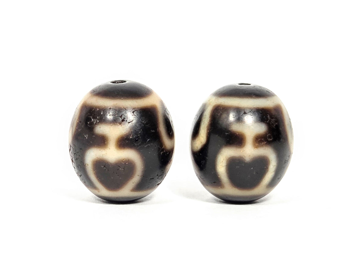 V-071426-TVV Treasure Vase pair face A alternate — vase silhouette, cream etching, dark brown agate, unretouched.
