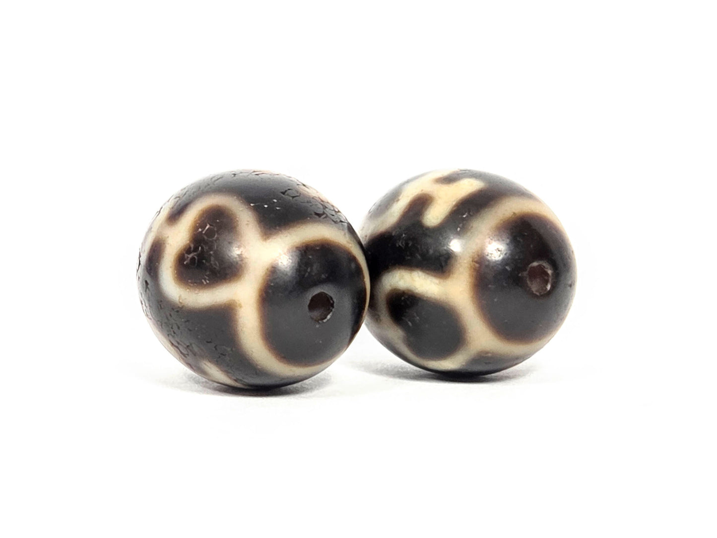 Treasure Vase Variant pair V-071426-TVV drill-end angle A — cream network wrapping equator, dark brown agate, unretouched.