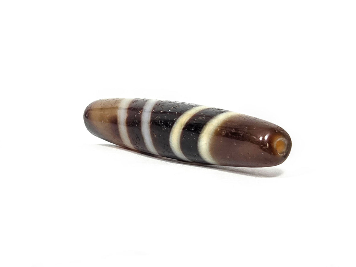 V-052222-7SChung, right tip 3/4 view, broad rounded end, honey-brown agate tip, drill hole visible, unretouched