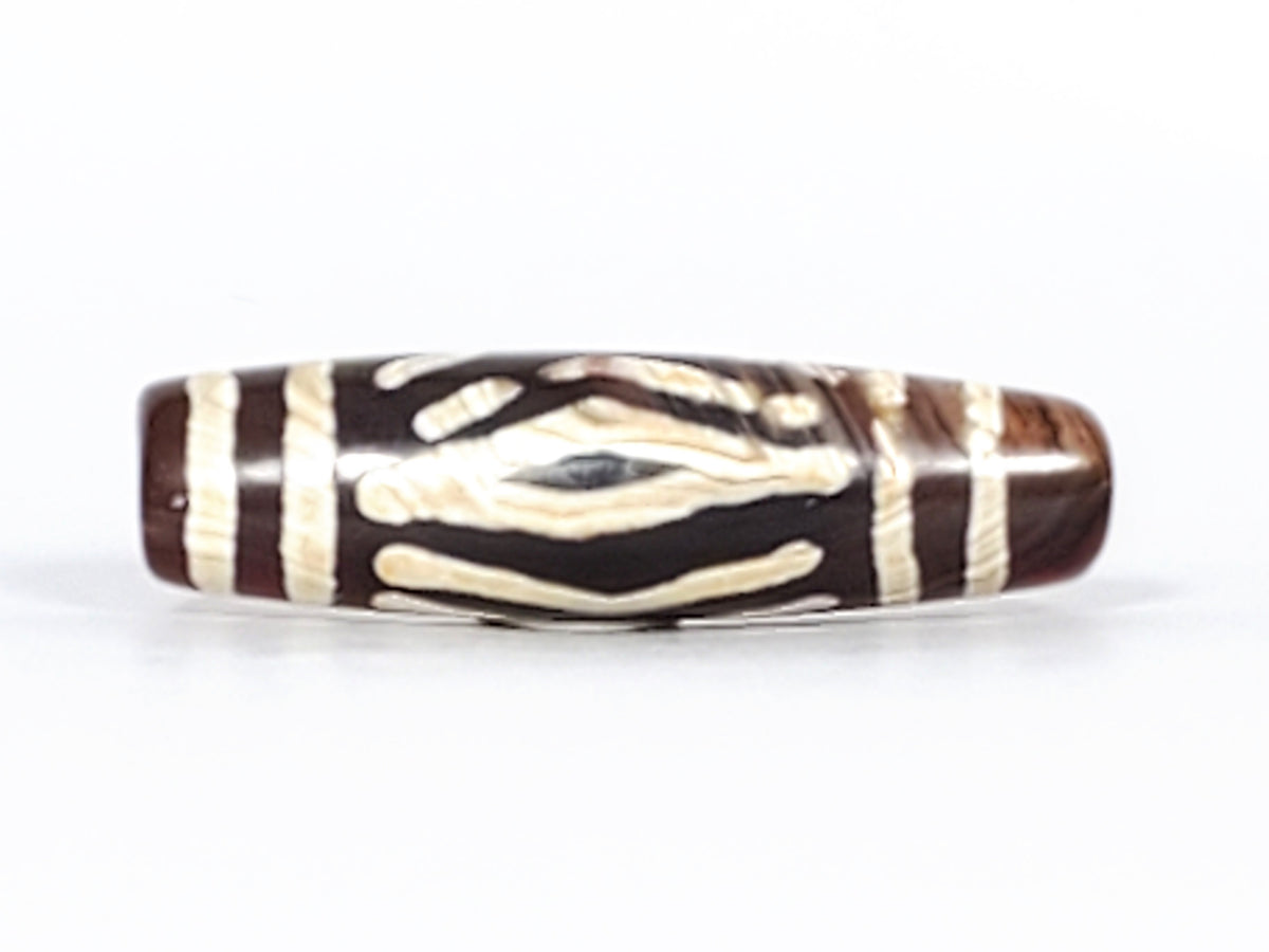 Antique carnelian dzi bead with two diamond eyes and tiger tooth motif, brown agate, cream etched pattern, aged patina