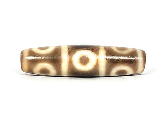 Ancient Tibetan eight-eye dzi bead, warm brown agate, two rows of four cream eyes, unretouched