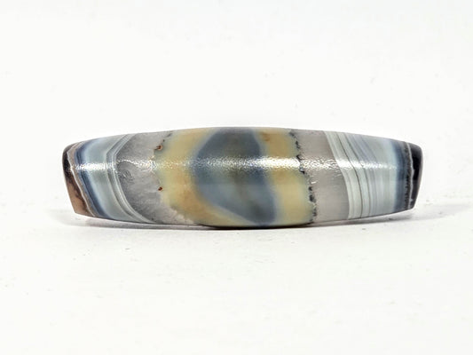 Antique natural dzi bead with unretouched naturally formed eye pattern in grey cream and slate blue banding — no etching or artificial treatment