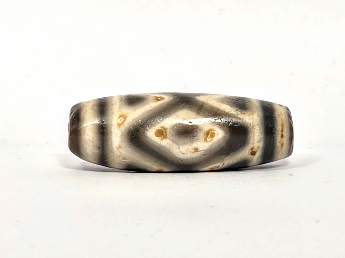 Ancient Tibetan dzi bead, three diamond eye tiger tooth motif, cream agate with dark etching and cinnabar bloodspots, Ancient Dzi Shop
