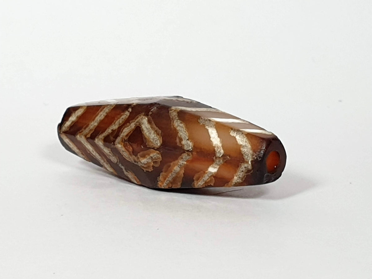 Ancient carnelian dzi bead, hexagonal, tiger stripe and three-eye motif, brown agate, white etched lines, visible drill hole, aged patina