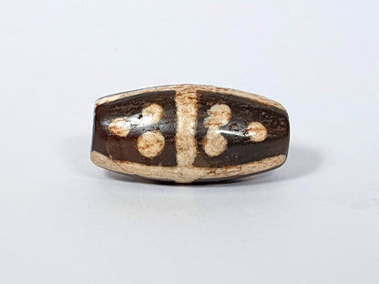 Ancient eighteen star motif agate dzi beads with tan and dark brown patterning, visible drill holes and patina