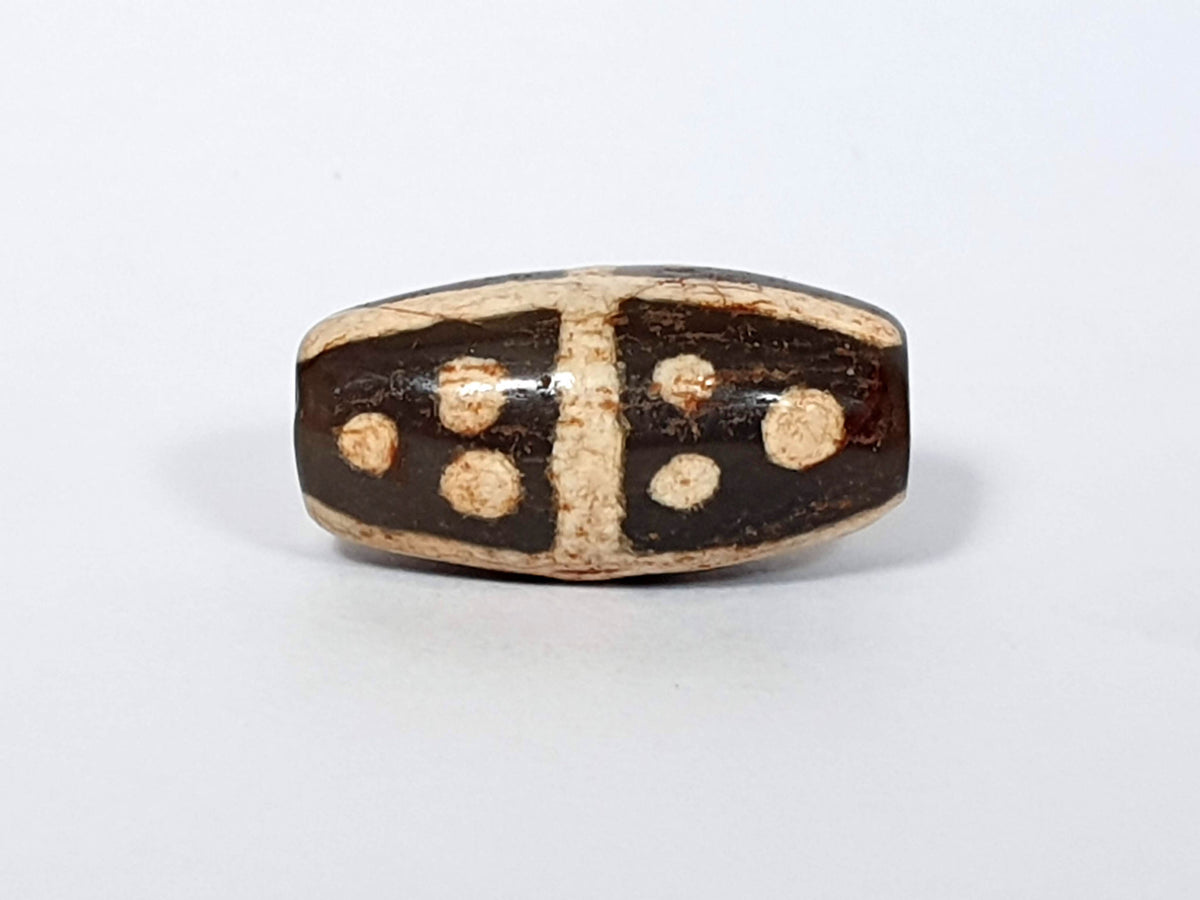 Ancient eighteen star motif agate dzi bead with dark brown surface and cream-colored eye patterns, natural patina