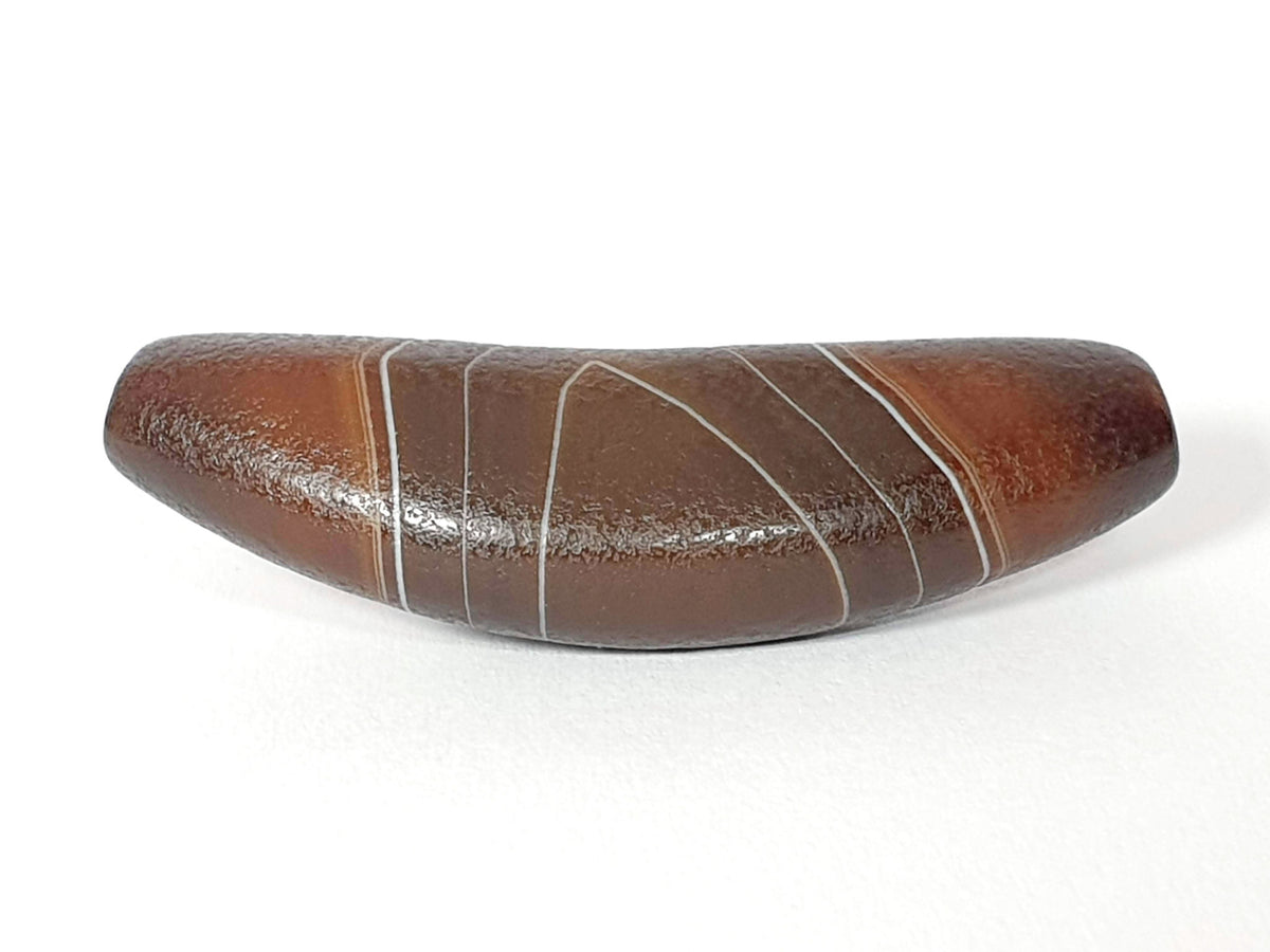 Bow shaped natural banded agate dzi bead with white stripe patterns and glossy brown surface finish