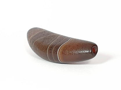 Bow-shaped natural banded agate dzi bead with white stripes and red bloodspot detail on brown stone
