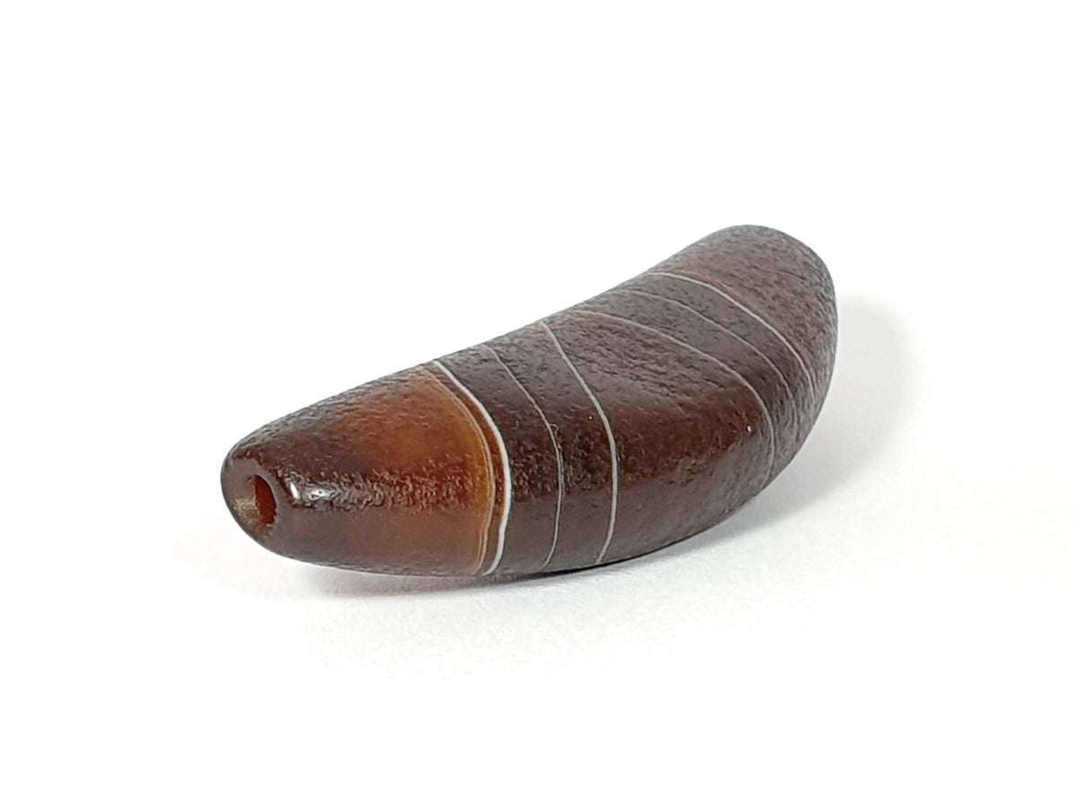 Bow-shaped natural banded agate dzi bead with white stripes and drilled hole, brown striped pattern