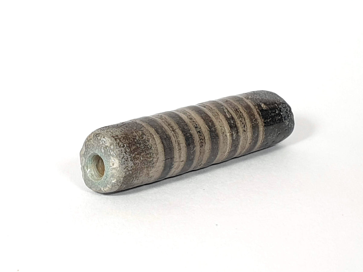 Ac-080420-19SChung, Bead A right end, large ancient drill hole with mineral deposit, encrusted end cap, unretouched
